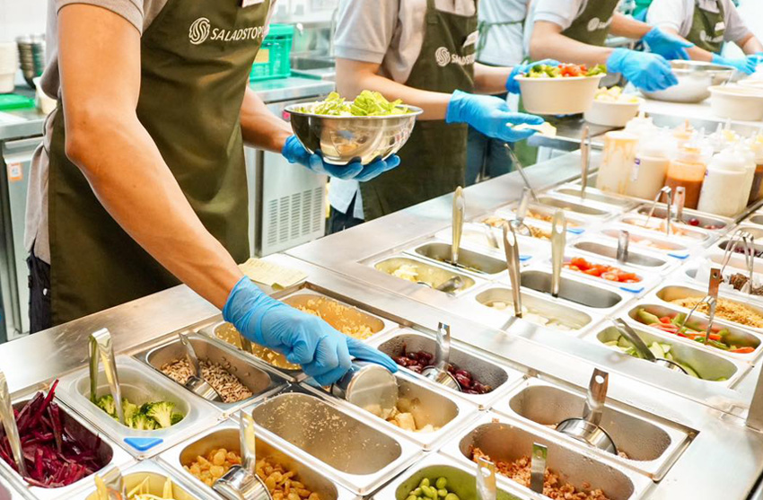 SaladStop! staff preparing order.